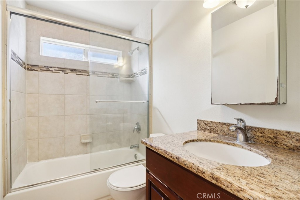 12106 Old River School Road, Unit G Downey, CA 90242 - Photo 17 of 22 a bathroom with a granite countertop sink toilet and shower