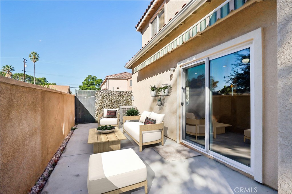 12106 Old River School Road, Unit G Downey, CA 90242 - Photo 18 of 22 a balcony with furniture and a potted plant