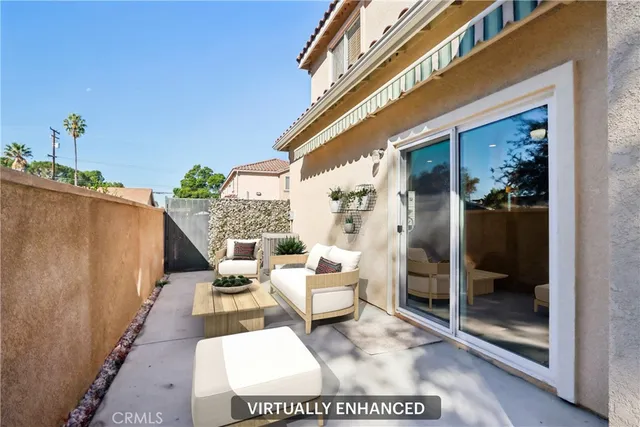 a balcony with furniture and a potted plant