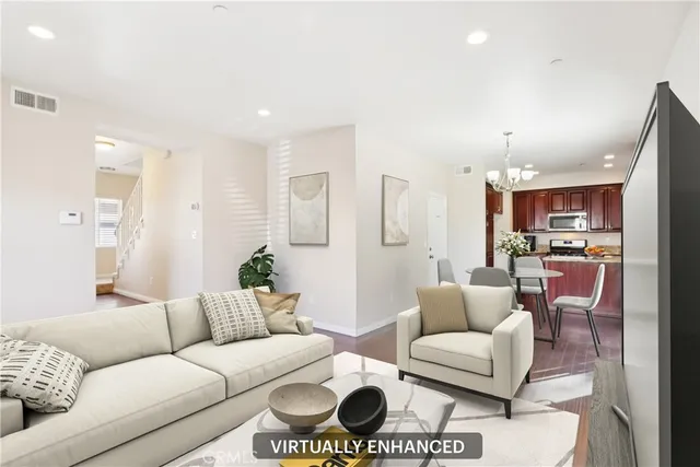 a living room with furniture and a view of kitchen