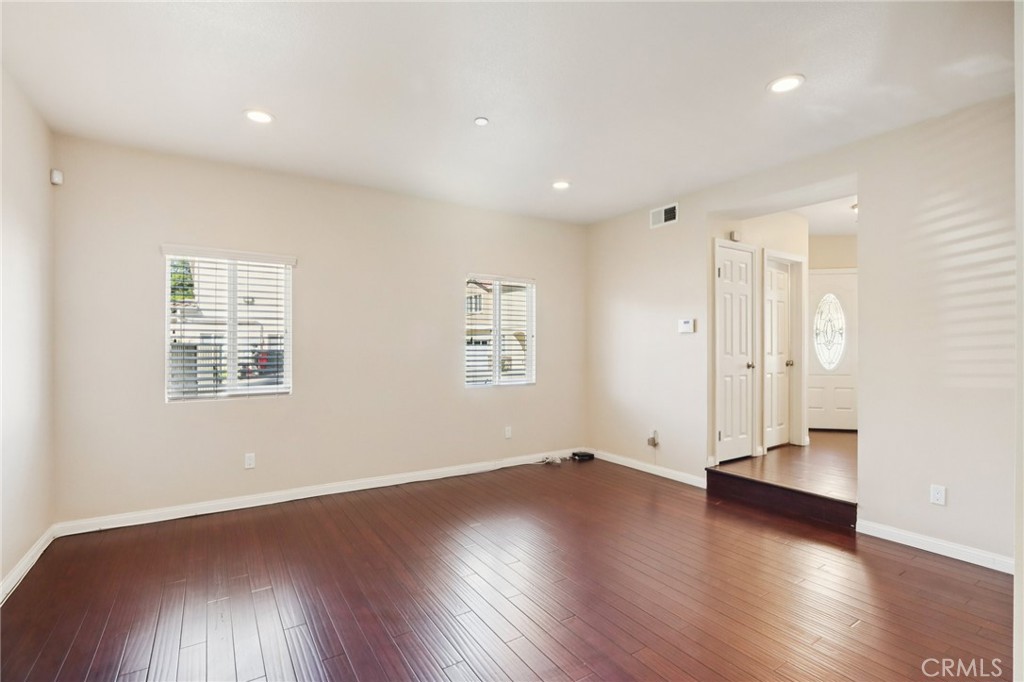 12106 Old River School Road, Unit G Downey, CA 90242 - Photo 5 of 22 an empty room with wooden floor and windows