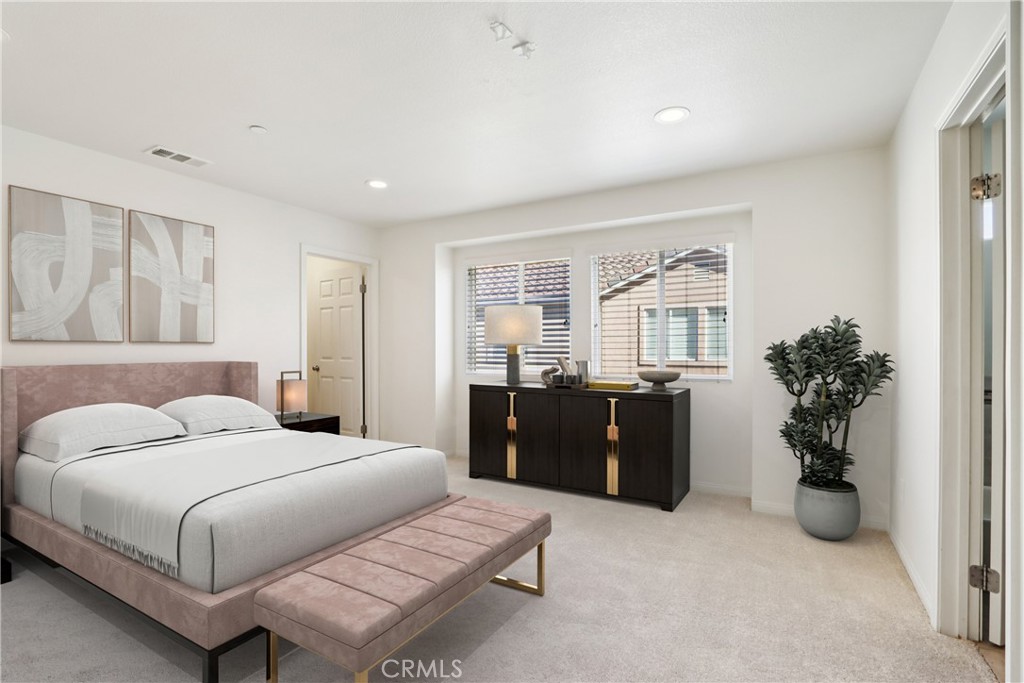 12106 Old River School Road, Unit G Downey, CA 90242 - Photo 8 of 22 a bedroom with a bed and potted plant