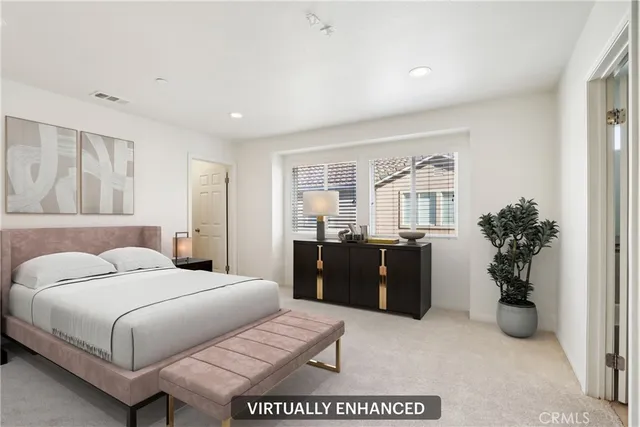 a bedroom with a large bed and potted plant