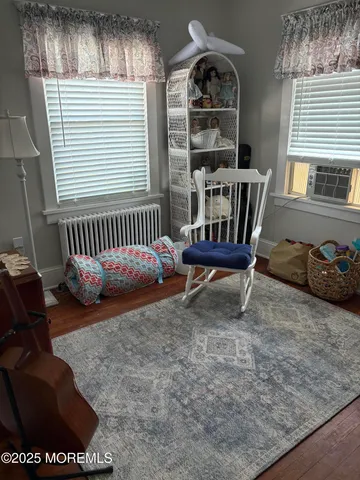 a view of a bedroom with furniture and windows