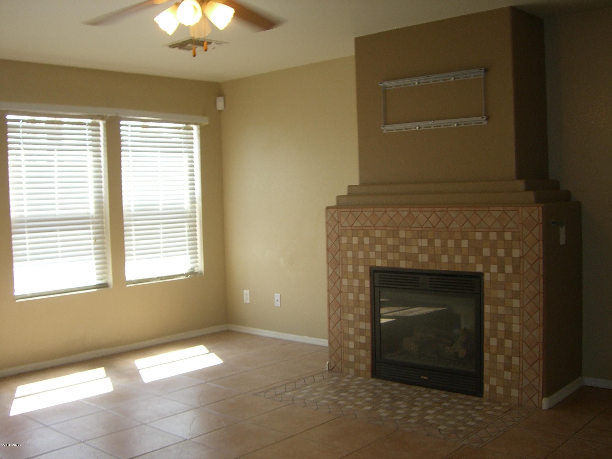 3281 South Martingale Road Gilbert, AZ 85297 - Photo 10 of 34 TILED FIREPLACE IN THE LIVING ROOM