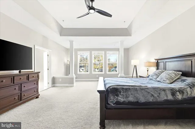 a bedroom with a large bed and flat screen tv