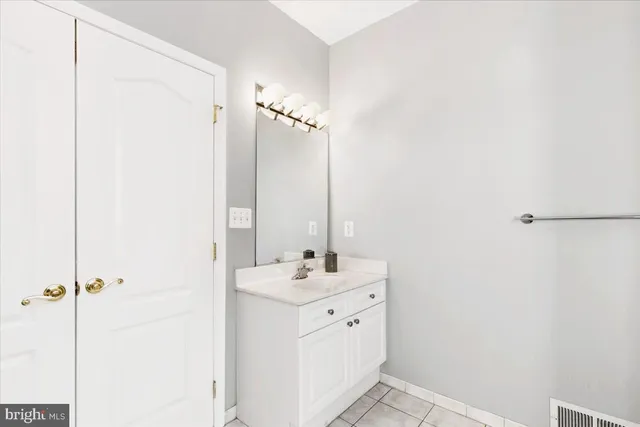 a bathroom with a double vanity sink a mirror and a shower