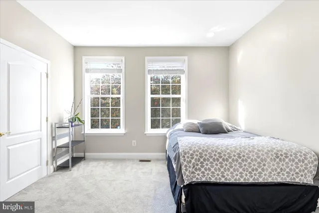 a bedroom with a bed and glass window