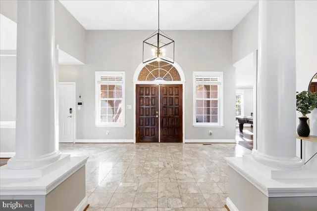 a view of a room with wooden floor and windows