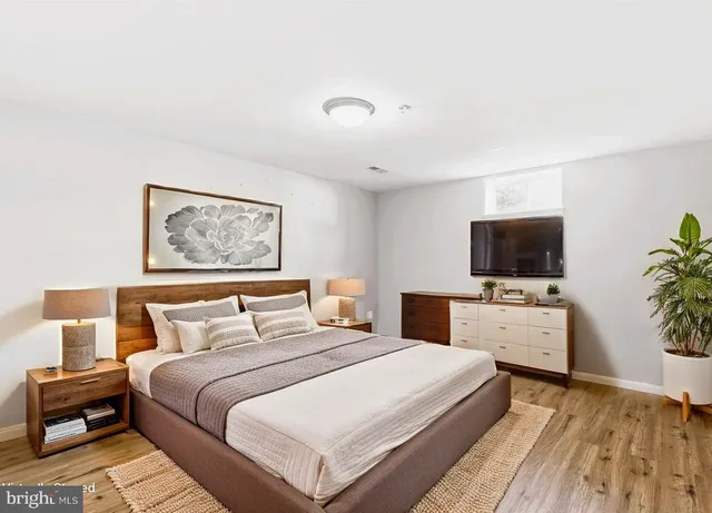 a bedroom with a bed and a flat screen tv