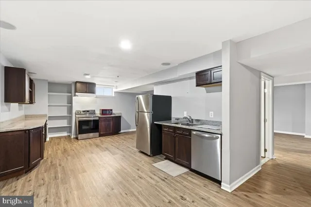 a kitchen with stainless steel appliances a refrigerator and a stove top oven