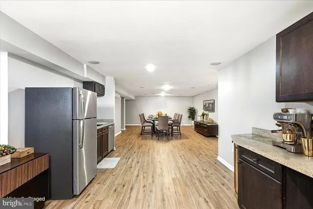 a view of a kitchen with sink and refrigerator