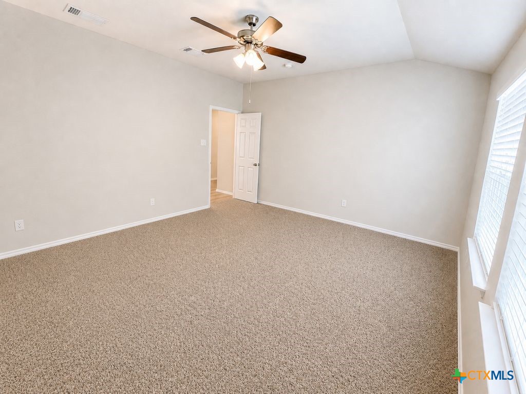 1507 Merritt Road Temple, TX 76504 - Photo 7 of 15 an empty room with a window and a ceiling fan