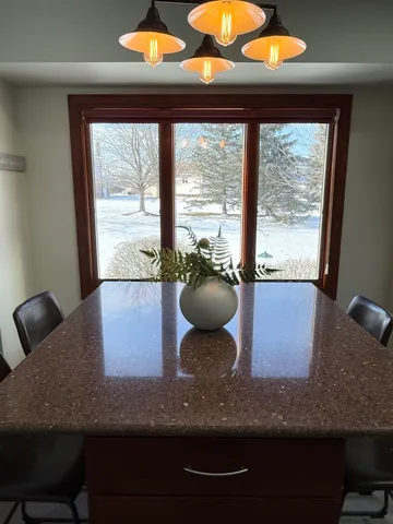 a view of a room with a large window and table