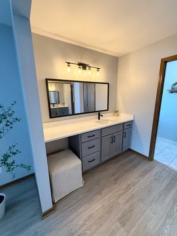 a spacious bedroom with a bed and a dresser