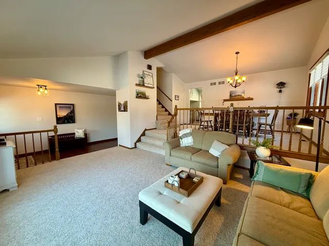 a living room with furniture and a chandelier
