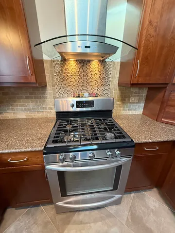 a stove top oven sitting inside of a kitchen
