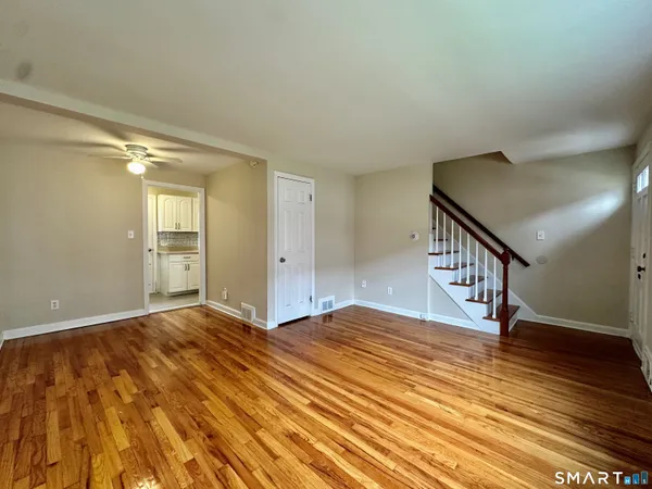 a view of an empty room and wooden floor