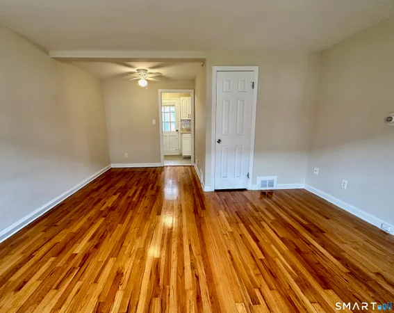 a view of room with wooden floor