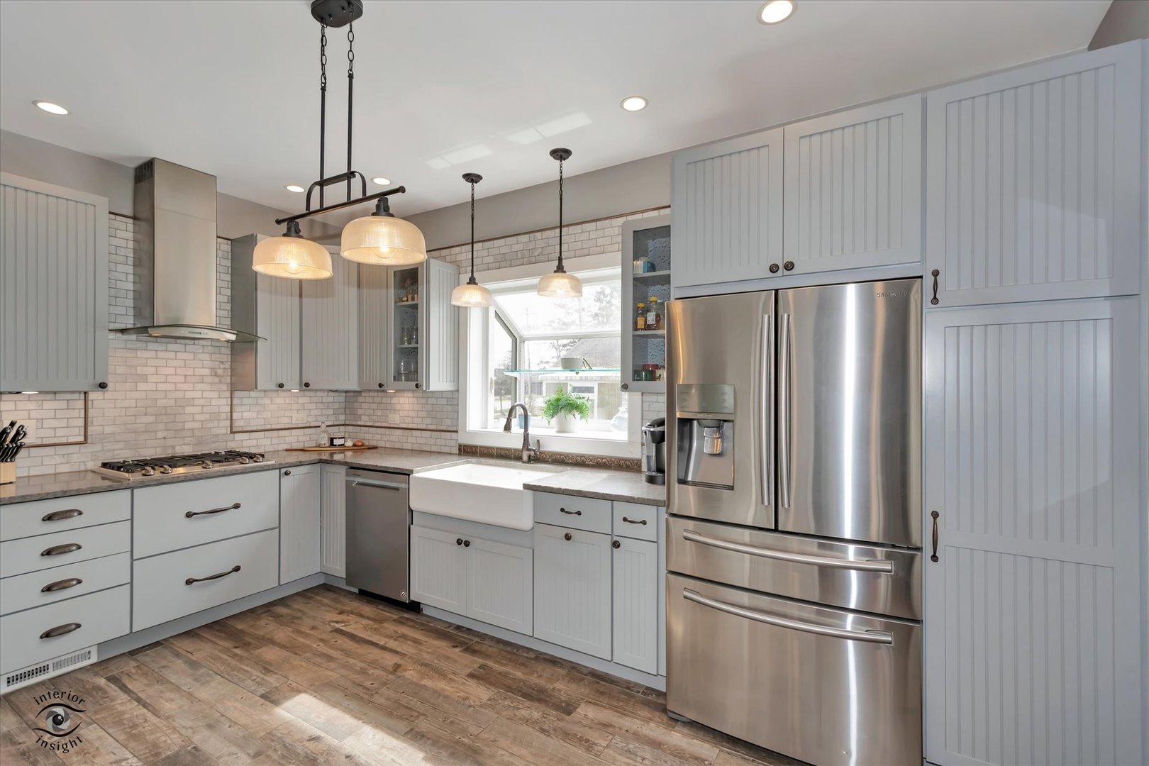 256 Center Road Frankfort, IL 60423 - Photo 12 of 26 a kitchen with white cabinets and stainless steel appliances