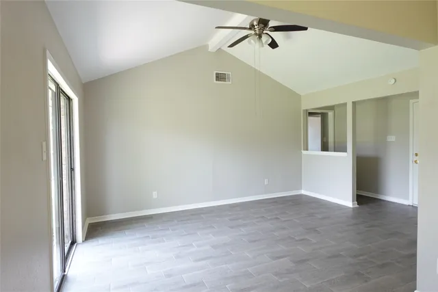 a view of a big room with closet and windows