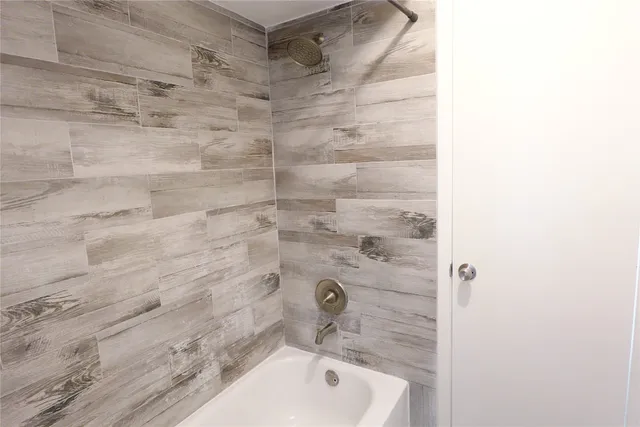 a bathroom with a shower and a sink