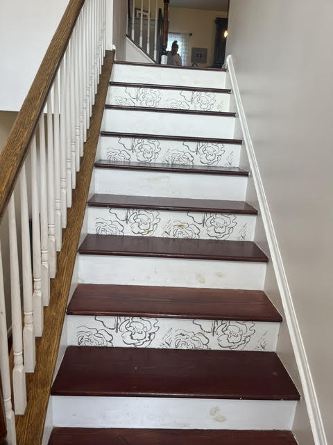 2212 Rising Hill Road Whitehall, PA 18052 - Photo 3 of 21 Ornate floral risers elevate this staircase, boasting rich wood treads and a classic baluster railing.