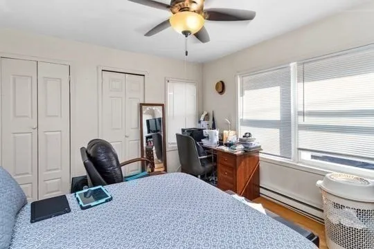 a bedroom with furniture and a window