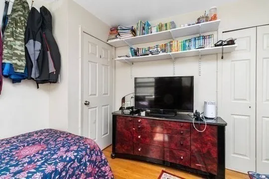 a bedroom with a bed and flat screen tv
