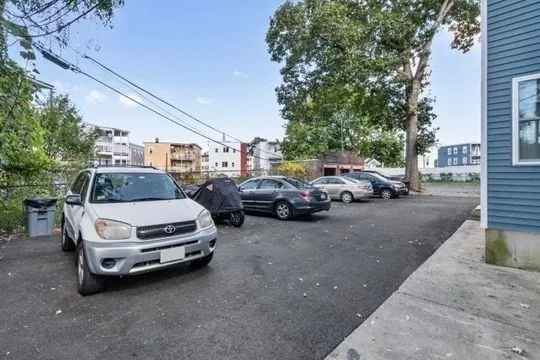 a view of cars parked on the side of a street