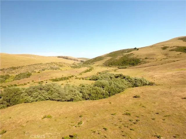 a view of an aerial view of mountain with an ocean