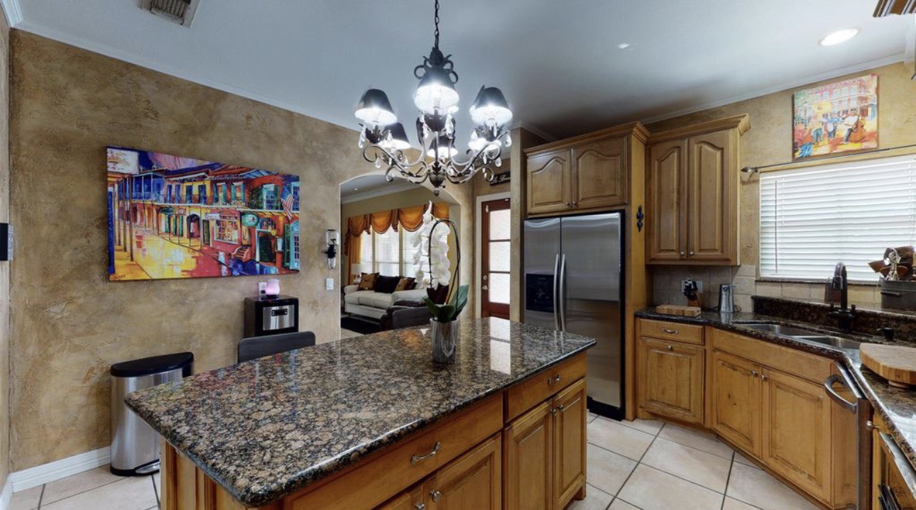 104 Mockingbird Lane Bridge City, TX 77611 - Photo 12 of 27 a kitchen with stainless steel appliances granite countertop a sink refrigerator and cabinets