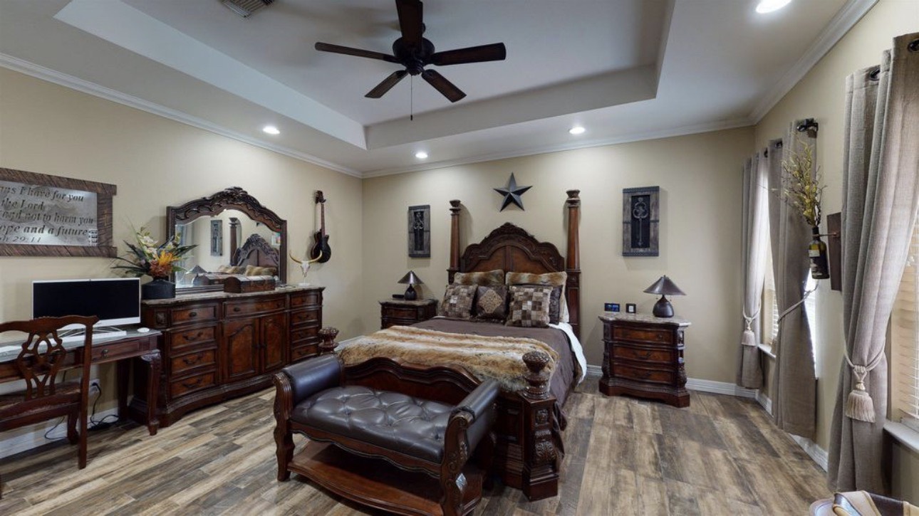 104 Mockingbird Lane Bridge City, TX 77611 - Photo 13 of 27 a bedroom with furniture and a wooden floor