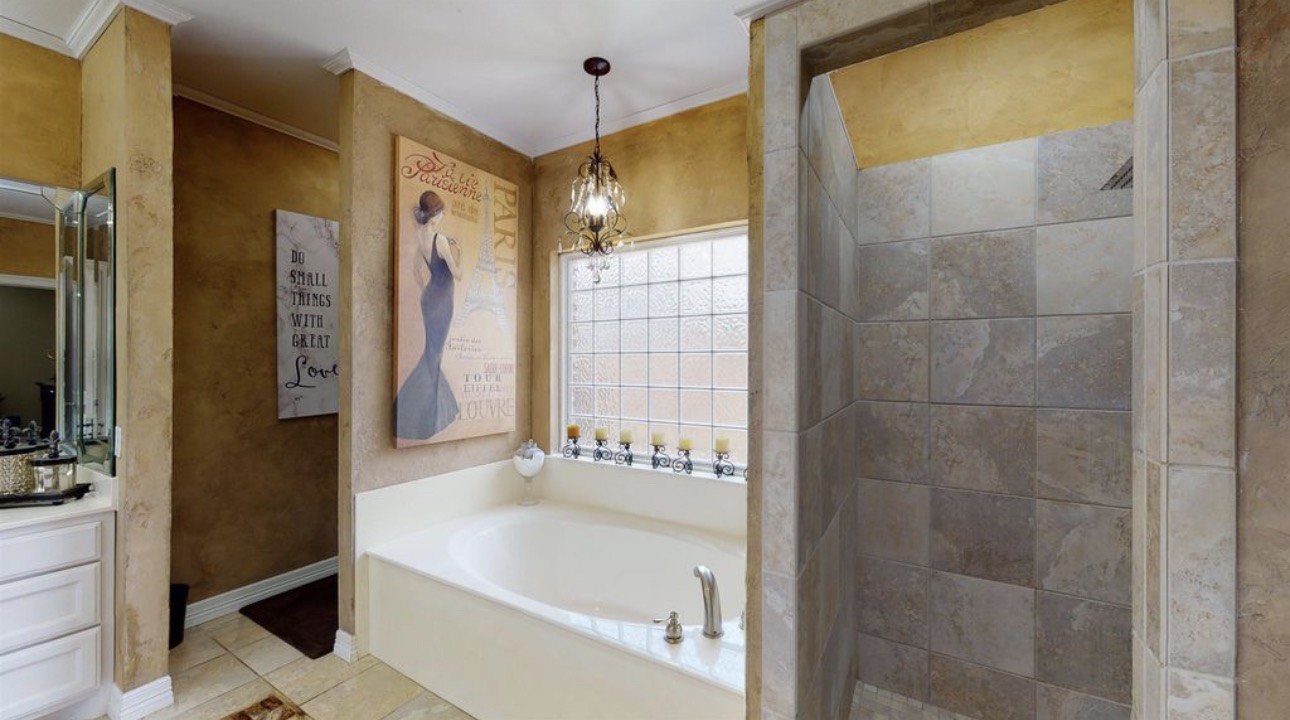 104 Mockingbird Lane Bridge City, TX 77611 - Photo 16 of 27 a bathroom with a bathtub and a shower