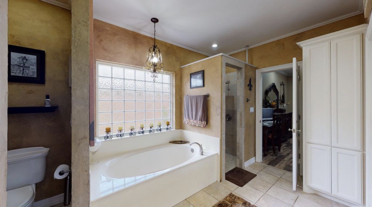 104 Mockingbird Lane Bridge City, TX 77611 - Photo 17 of 27 a bathroom with a bathtub a shower and a sink
