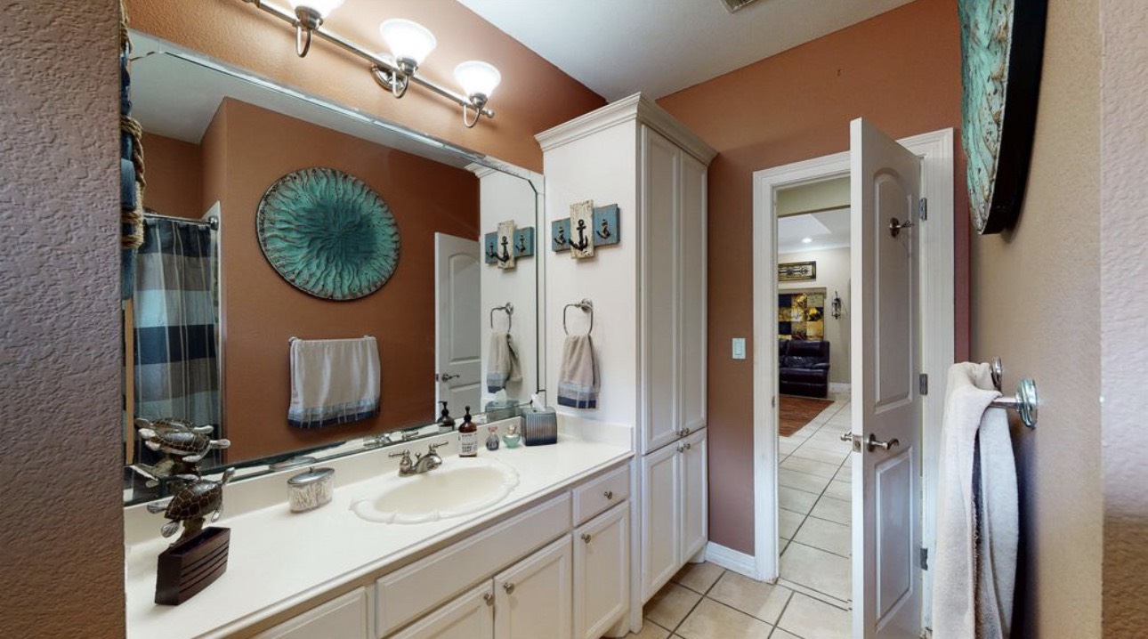 104 Mockingbird Lane Bridge City, TX 77611 - Photo 20 of 27 a bathroom with a sink vanity and a mirror