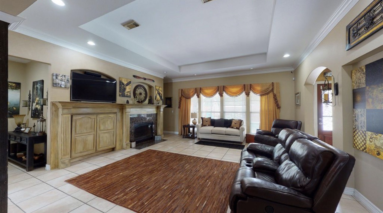 104 Mockingbird Lane Bridge City, TX 77611 - Photo 5 of 27 a living room with furniture a fireplace and a flat screen tv