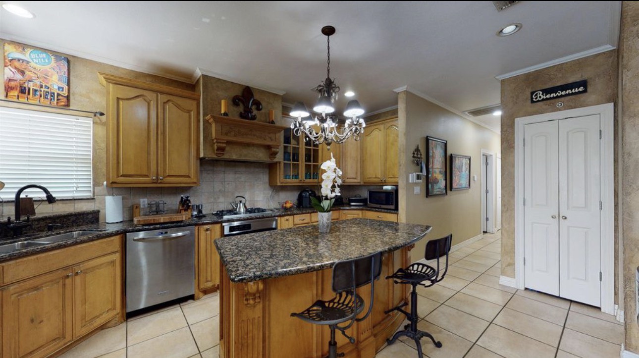 104 Mockingbird Lane Bridge City, TX 77611 - Photo 9 of 27 a kitchen with stainless steel appliances granite countertop a sink a stove and refrigerator