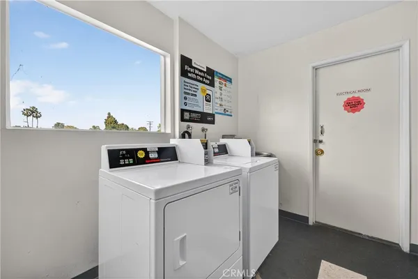 a view of a livingroom with workspace and a window