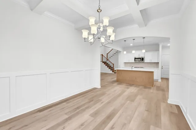 a view of a kitchen with a sink dishwasher a kitchen counter space and wooden floor