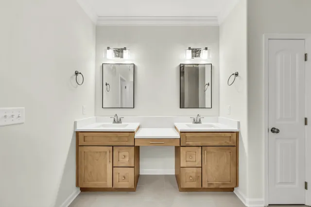 a bathroom with 2 sink and a mirror