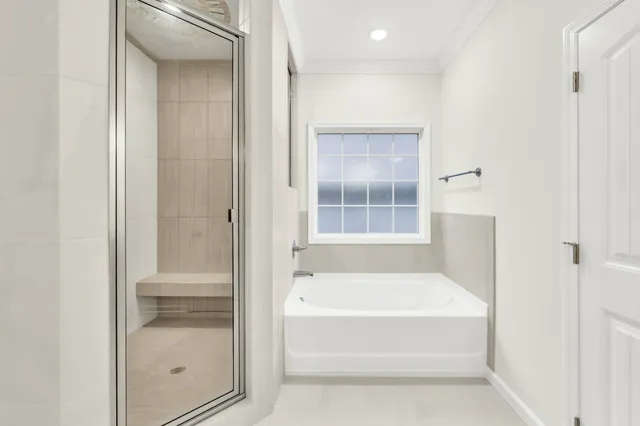 a bathroom with a tub and shower