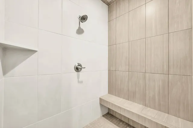 a bathroom with a white bathtub and shower