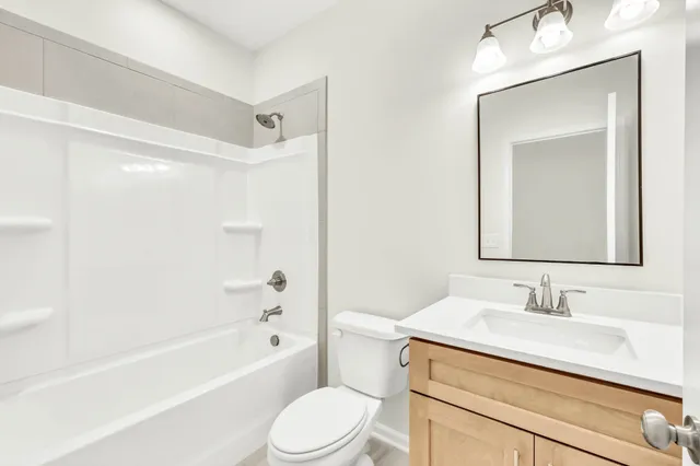 an empty room with windows and ceiling fan