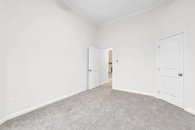 an empty room with windows and ceiling fan