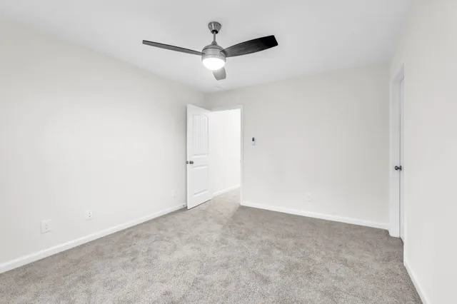 a bathroom with a sink toilet vanity and mirror
