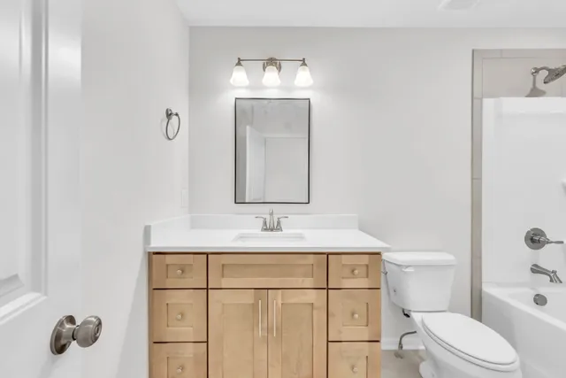 an empty room with a ceiling fan and a window