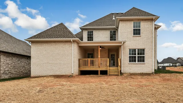 a view of dirt yard with a large tree