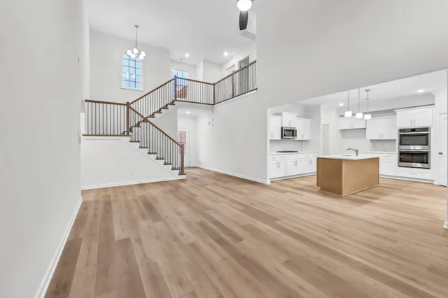 a view of a kitchen with furniture and wooden floor