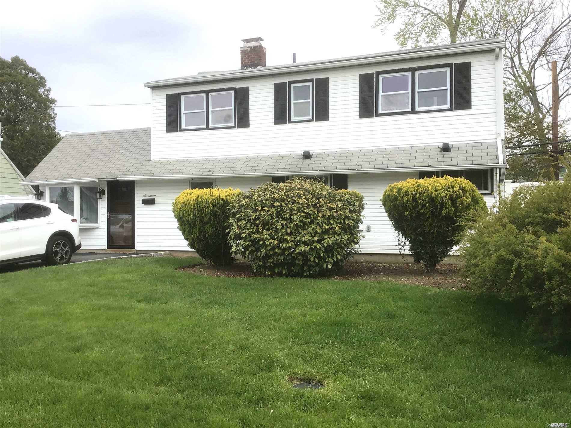 17 Friendly Road Hicksville, NY 11801 - Photo 1 of 1 a front view of a house with a garden